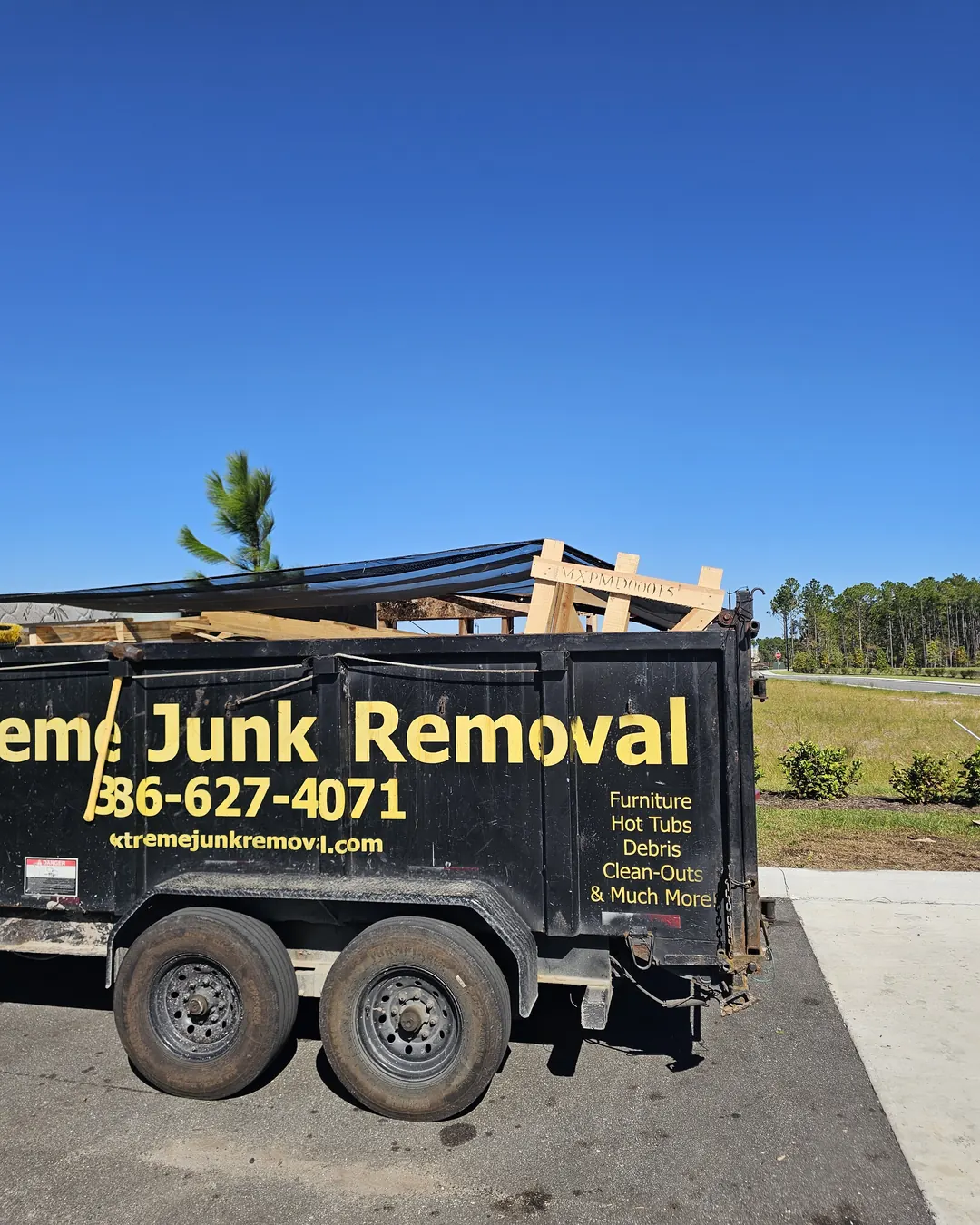Warehouse & Flex Space Cleanouts Extreme Junk Removal dump trailer loaded with pallets on a job