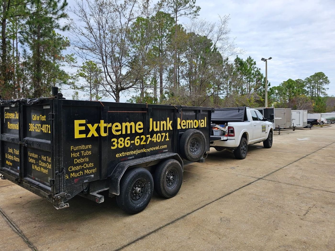 Extreme Junk Removal truck and 15-yard dump trailer in Palm Coast, FL