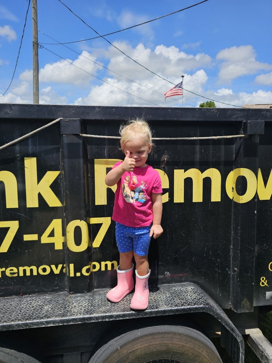 Family-owned Extreme Junk Removal trailer with a thumbs up